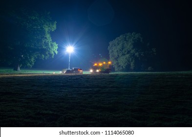Night Time Road Assistance As A Rescue Truck Comes To The Aid Of A Broken Down Car. Photo To Illustrate A 24 Hour Service Industry