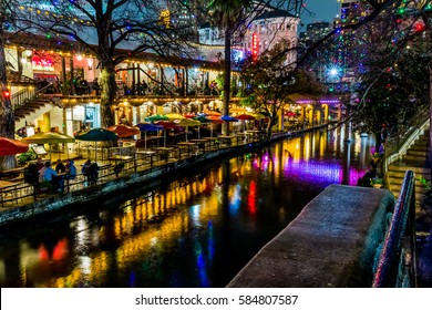 Night Time Scenic View of the Historic Texas Riverwalk with Christmas Lights on a Rainy Night in San Antonio, Texas.