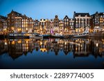 Night time shot of the Singel canal, Amsterdam with historic buildings along the bank