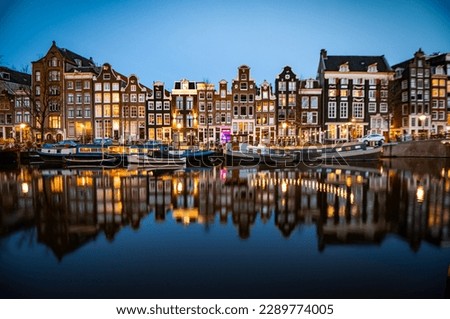 Night time shot of the Singel canal, Amsterdam with historic buildings along the bank
