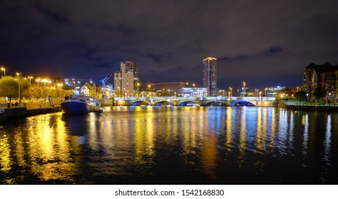 Night time skyline view of Belfast with the Lagan River with bridge and building in background. Belfast, Ireland, October 23, 2019