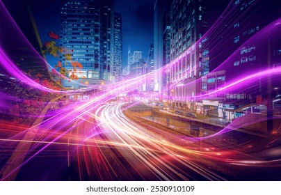 Night time view of a busy highway with traffic light trails.  A cityscape of tall buildings. - Powered by Shutterstock