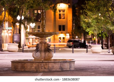 Night time view of a historic public fountain in downtown Santa Ana, California, USA.