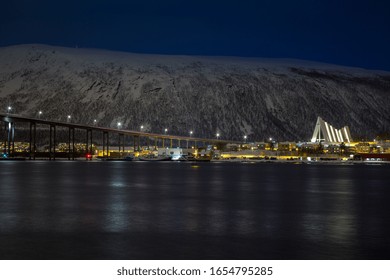 Night Time View Of Tromsdalen And The Illuminated Arctic Cathedral From  Tromsø In Winter.