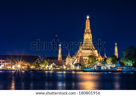 Night time view of Wat Arun (Temple)  across Chao Phraya River in Bangkok, Thailand.