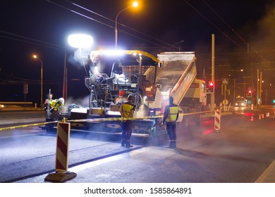 Night Time Workers Repairing Street Asphalt With Heavy Machinery