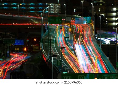 A Night Timelapse Of The Traffic Jam At The Urban Street In Tokyo Long Shot. High Quality Photo. Shinagawa District Tokyo Japan 04.22.2022 Here Is Highway Side In Tokyo. Translation On Billboards Text