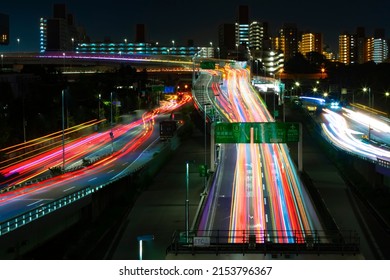 A Night Timelapse Of The Traffic Jam At The Urban Street In Tokyo. High Quality Photo. Shinagawa District Tokyo Japan 04.22.2022 Here Is Highway Side In Tokyo. Translation On Billboards Text Area Name