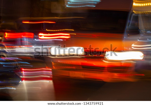 night traffic of cars in a blur, the\
lights from cars and flashlights at night in the\
blur
