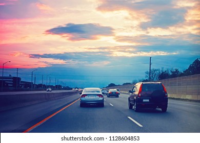 Night Traffic. Cars On Highway Road On Sunset Evening In Busy Toronto City In Canada. Beautiful Amazing Night Urban View With Red, Yellow And Blue Sky Clouds. Toned With Film Filters 