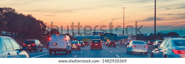 Night
traffic. Cars on highway road at sunset evening in busy american
city. Beautiful amazing urban view with red, yellow, blue sky.
Sundown in downtown. Web header banner for
website.