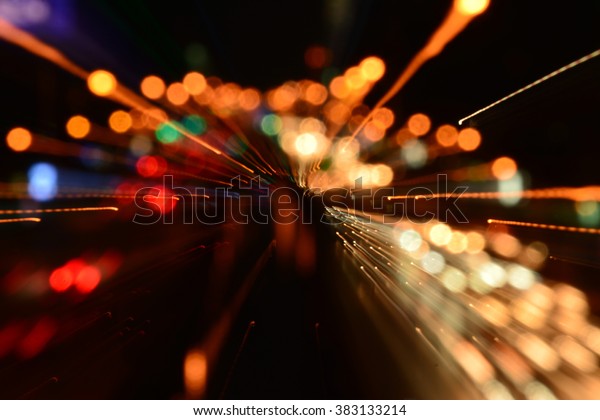 Night traffic in the city, car lights in motion\
blur with zoom effect