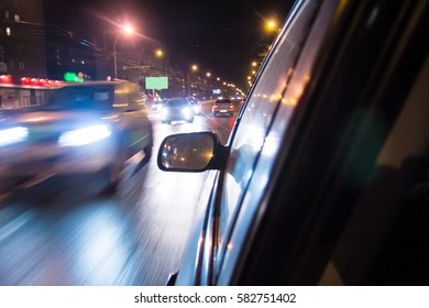 Night traffic, in motion from passenger window.
