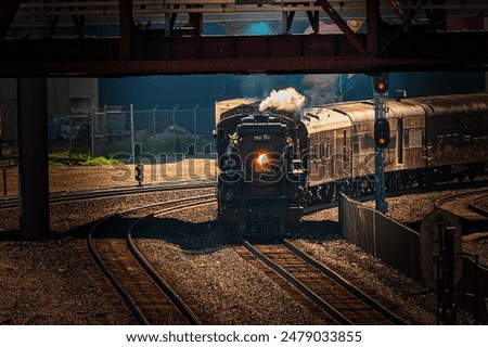 A night train passing under a bridge on tracks