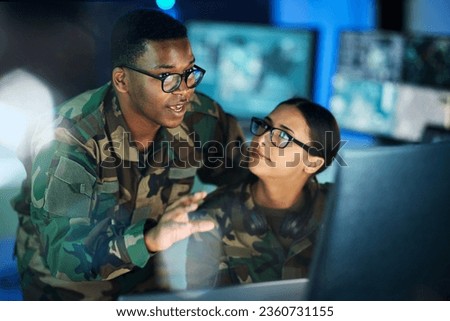 Night training, army and people with a computer for communication, planning strategy or surveillance. Cyber security, data center and a black man talking to a woman about monitor in a military room