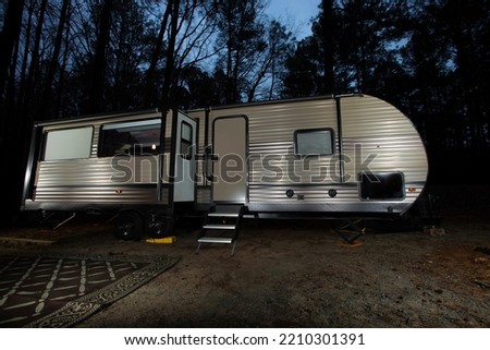 Night travel trailer in a forest near Jordan Lake in North Carolina