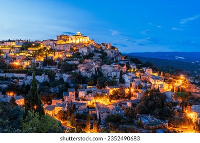 Night view of ancient Provencal town Gordes at dusk with warm lights on the streets. Gordes in Provence; France, Luberon is popular landmark and tourist destination. - Powered by Shutterstock