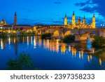 Night view of the basilica de nuestra senora de pilar, catedral del salvador de zaragoza and puente de piedra in Zaragoza, Spain.