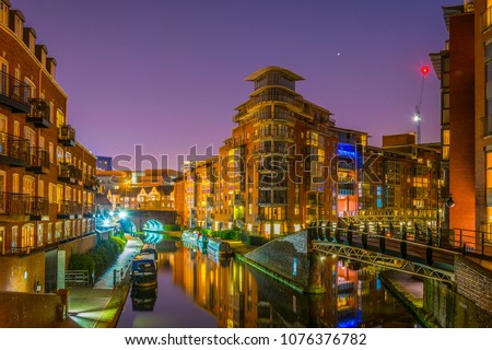 Night view of brick buildings alongside a water channel in the central Birmingham, England