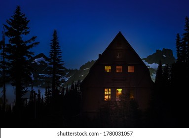 Night View Of A Cabin In The Woods With Lit Windows; Mountains With Snow Spots And Dark Blue Sky In Background