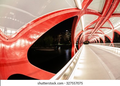 Night view of Calgary's Peace Bridge. The bridge features a red and white helix design. Opened in March 2012, it connects the extensive Bow River Pathway on the north and south sides of the Bow River.