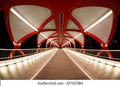 Night view of Calgary's Peace Bridge. The bridge features a red and white helix design. Opened in March 2012, it connects the extensive Bow River Pathway on the north and south sides of the Bow River.