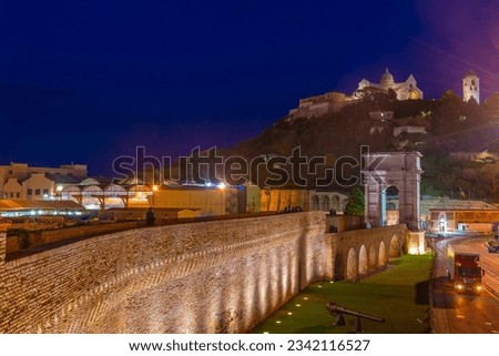 Night view of cathedral of San Ciriaco behind Arco di Traiano in Ancona, Italy.