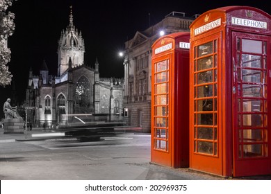 Night view of classic red British telephone box against B&W background - Powered by Shutterstock