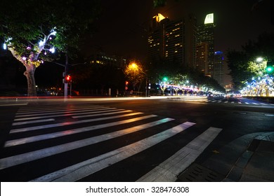 Night View Of Crosswalk And Pedestrian At Modern City Zebra Crossing Street. Blur Abstract.