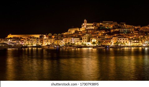 Night view of Dalt Vila, Ibiza old town. Night reflections on the sea.