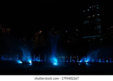 Night view of the dancing multi-colored fountains. Show of Singing Fountains. Kuala Lumpur / Malaysia - 02.27.2020