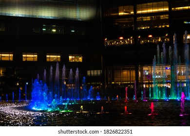 Night view of the dancing multi-colored fountains. Show of Singing Fountains. Kuala Lumpur, Malaysia - 07.18.2020