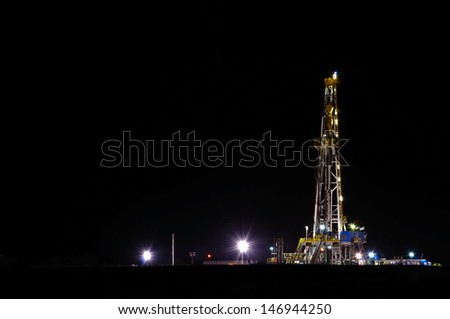 A night view of a derrick drilling in the Eagle Ford Shale.