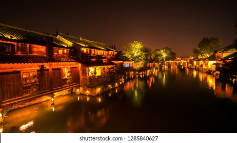 Night view of generic ancient town with water reflection. Traditional building along historic water town Wuzhen China - Powered by Shutterstock