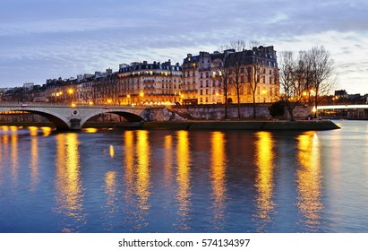 Night View Of The Ile Saint Louis Island And The Seine River In Paris, France