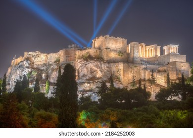 Night view of illuminated Akropolis with light beams directed into the sky, Athens, Greece