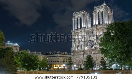 Night View of illuminated Notre Dame de Paris timelapse, France. View from Petit Bridge - Cardinal Lustiger