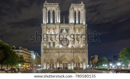 Night View of illuminated Notre Dame de Paris timelapse, France and square in front of the cathedral with people. Front view with tilt-shift lens