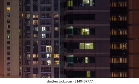 Night View Of Lights In Panoramic Windows Of Multistory Buildings Aerial Timelapse. Illuminated Skyscraper In A Big City