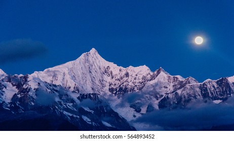 A Night View of Meili Snow Mountain with a full moon, Yunnan Province