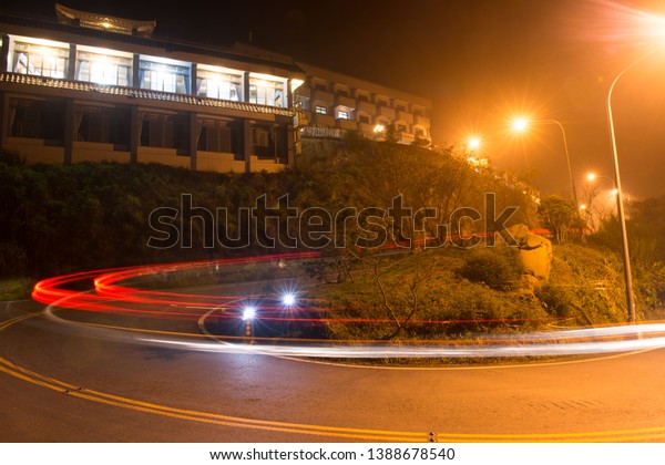 The night view of\
the mountains in Taiwan. In the evening, there are many cars\
passing through the road.\
