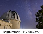 Night view of old observatory dome and telescope with the Milky Way visible in the background; San Jose, south San Francisco bay area; long exposure