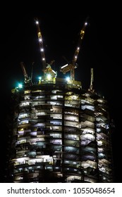 night view on under construction skyscraper. building illumination
