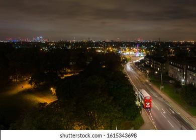 Night View Over A Busy Park And Road In London.