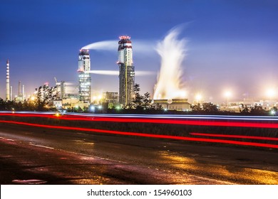 Night View Of A Plant For The Ammonia Production With Cars Light On A Background