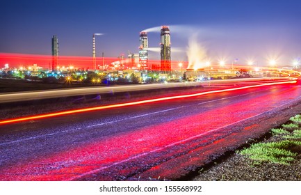 Night View Of A Plant For The Ammonia Production With Cars Light On A Background