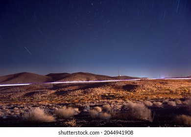 Night View From Plants And Hills In Desert With Light And Star Trails Ans North Star At Frame In Iran