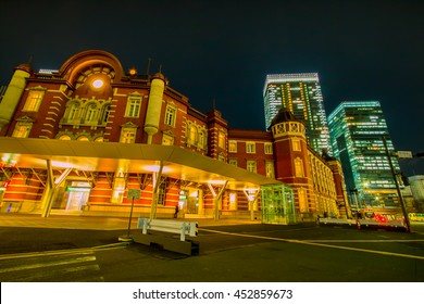 Night view point in Tokyo Station, Japan. Traffic light car drive across junction, Transportation in the big city.