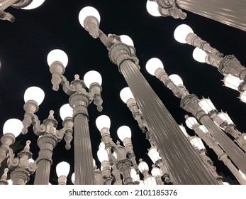 Night View of Public Art Urban Light, large-scale retro classical white street lamps sculpture, arranged in a near grid, which assemblage by Chris Burden. At Hollywood Los Angeles city