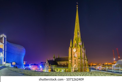 Night view of Saint Martin church surrounded with Bullring shopping mall in Birmingham, England